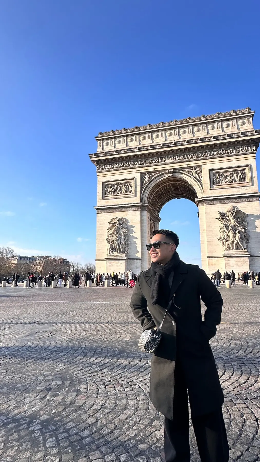 EJ standing near the Arc de Triomphe in Paris